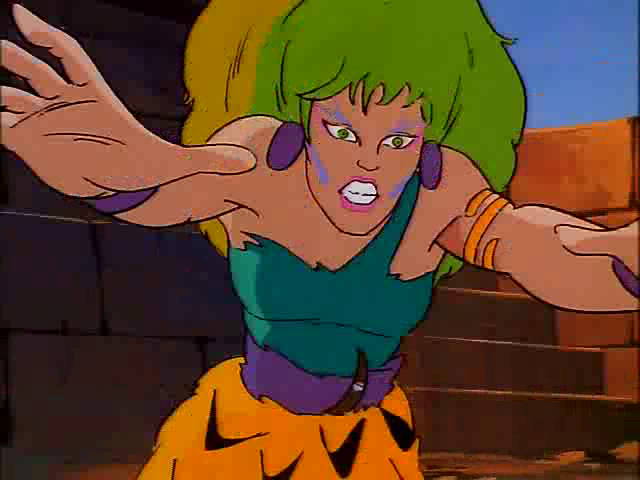 Screenshot from the episode of Jem, Season 1 Episode 8, "Starbright Rising Star", music video "Welcome To The Jungle", showing a wild-eyed Pizzazz pouncing towards the camera.