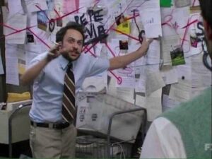 Pepe Silvia meme of Charlie Kelly looking manic  in front of a corkboard covered in scraps of paper connected by red tape.